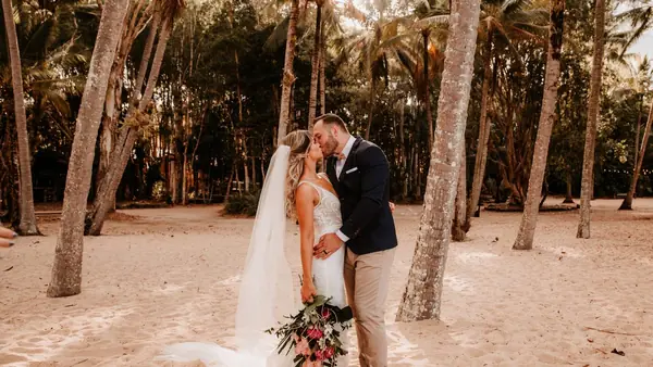 Couple embracing among coastal palms